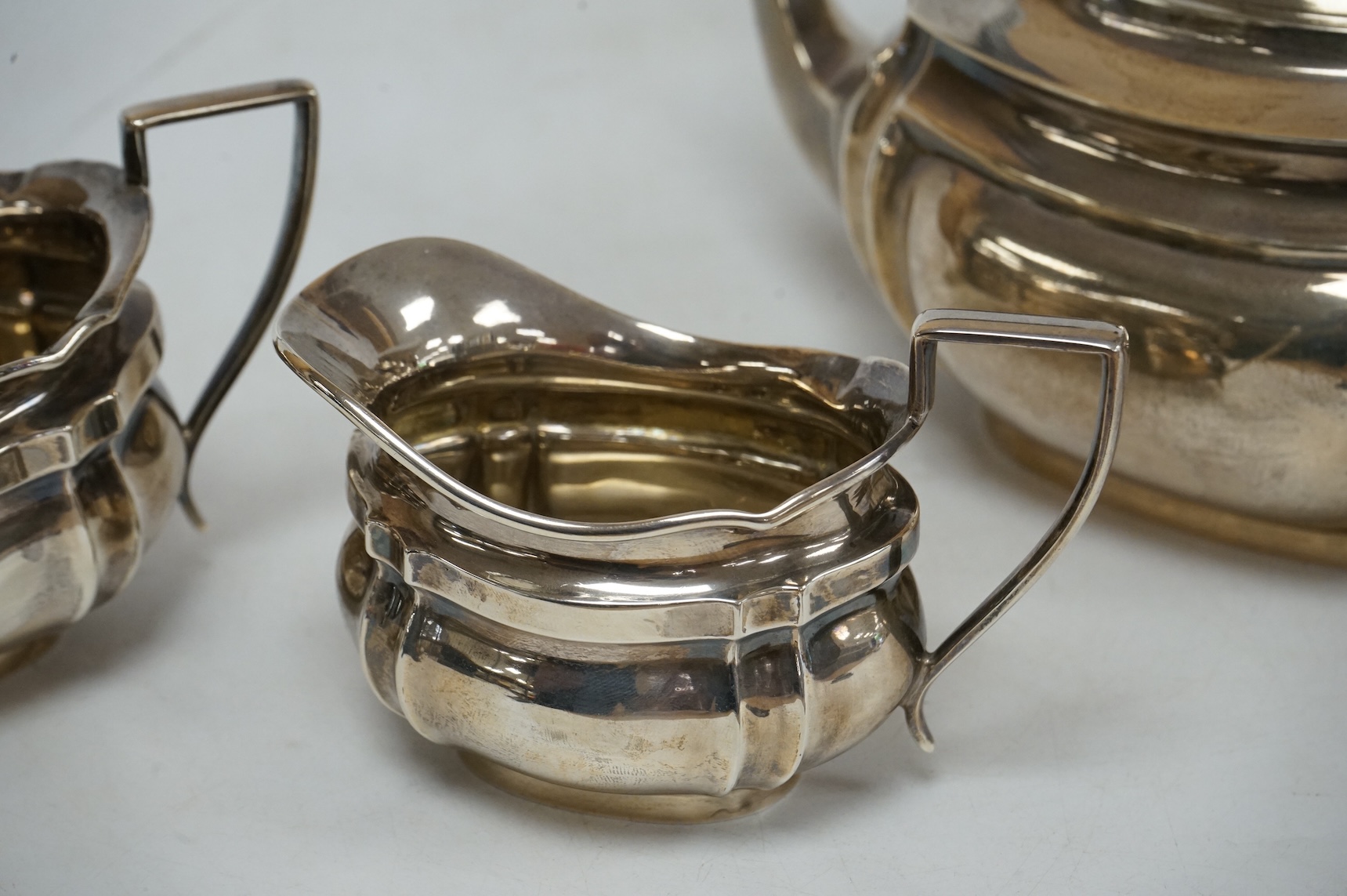 A George V silver oval three piece tea set, by Alexander Clark & Co Ltd, Birmingham, 1914 & 1916, gross weight 18.9oz.
